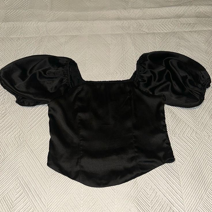 Black Satin Crop Top With Puffy Sleeve Never Worn Black Short Sleeve Crop Top For Evening, Chic Black Fitted Crop Top, Black Puff Sleeve Top For Party, Black Fitted Evening Crop Top, Fitted Black Crop Top For Evening, Black Puff Sleeve Crop Top For Spring, Elegant Black Padded Crop Top, Black Puff Sleeve Stretch Top, Chic Black Puff Sleeve Crop Top