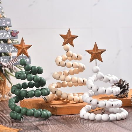 a christmas tree made out of wooden beads on a table next to other holiday decorations