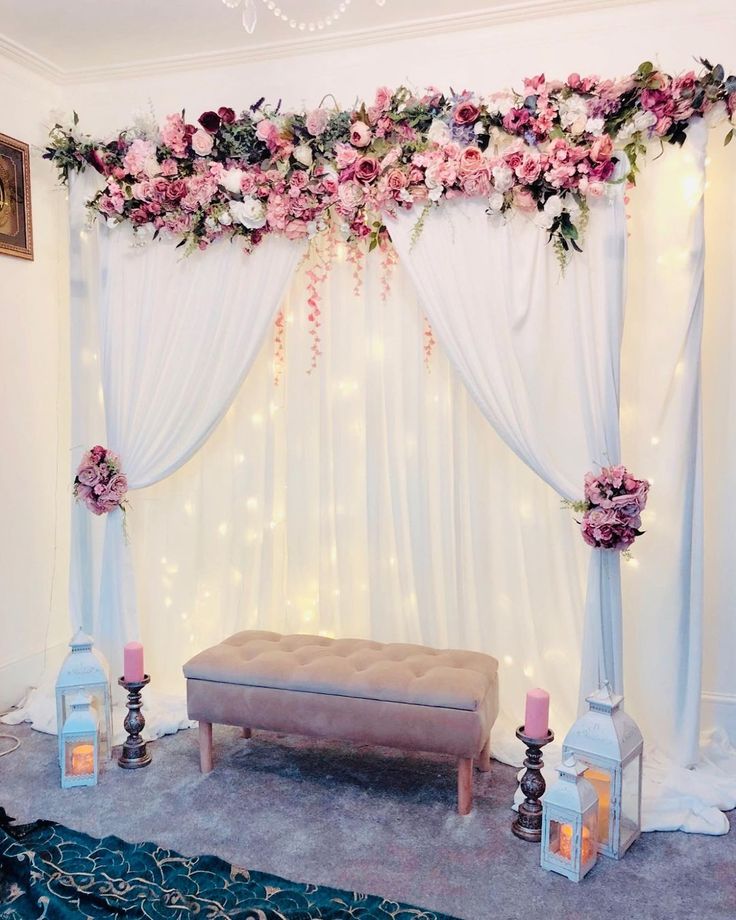 a decorated stage with flowers and candles on the floor for a wedding ceremony or reception