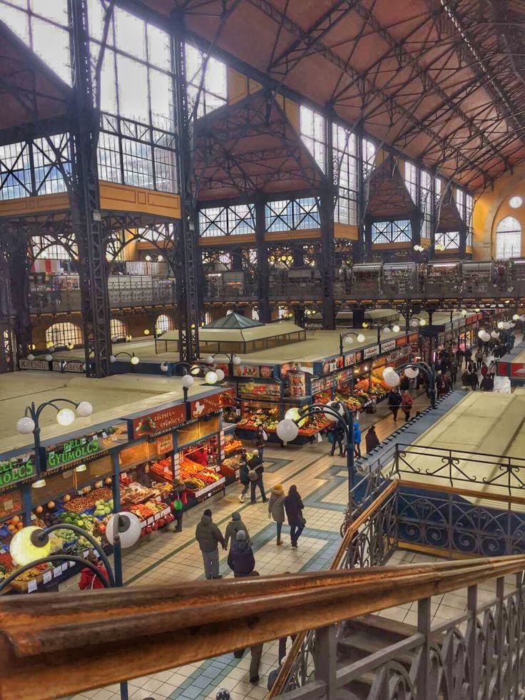 an indoor market with lots of people shopping