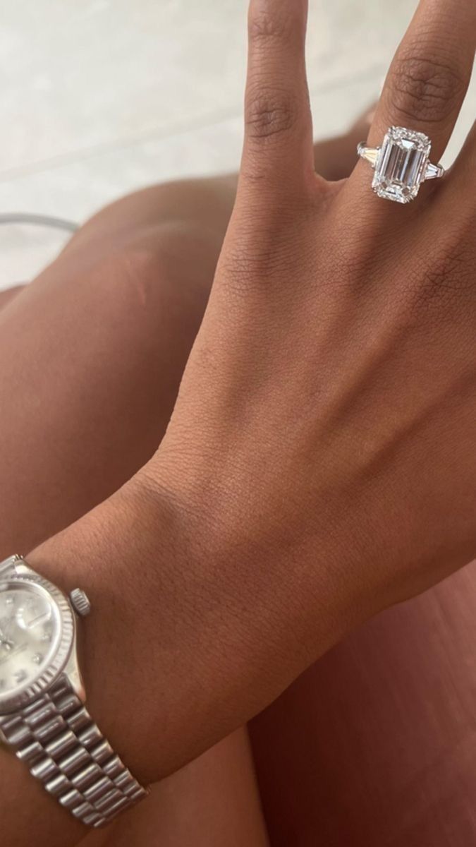 a close up of a person's hand with a watch on her left wrist