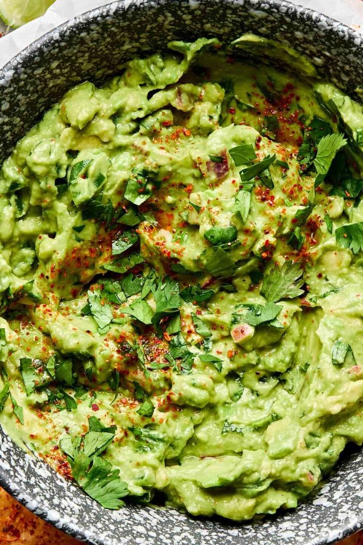 a bowl filled with guacamole on top of a table