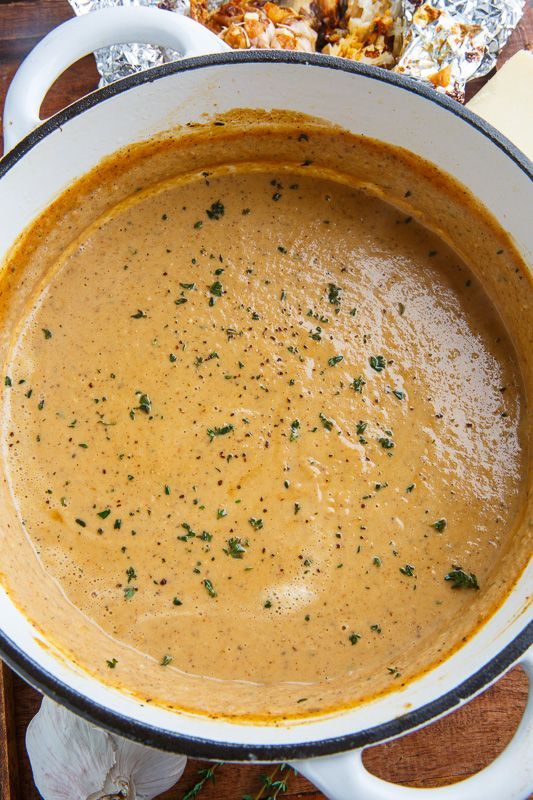 a bowl of soup sitting on top of a wooden table