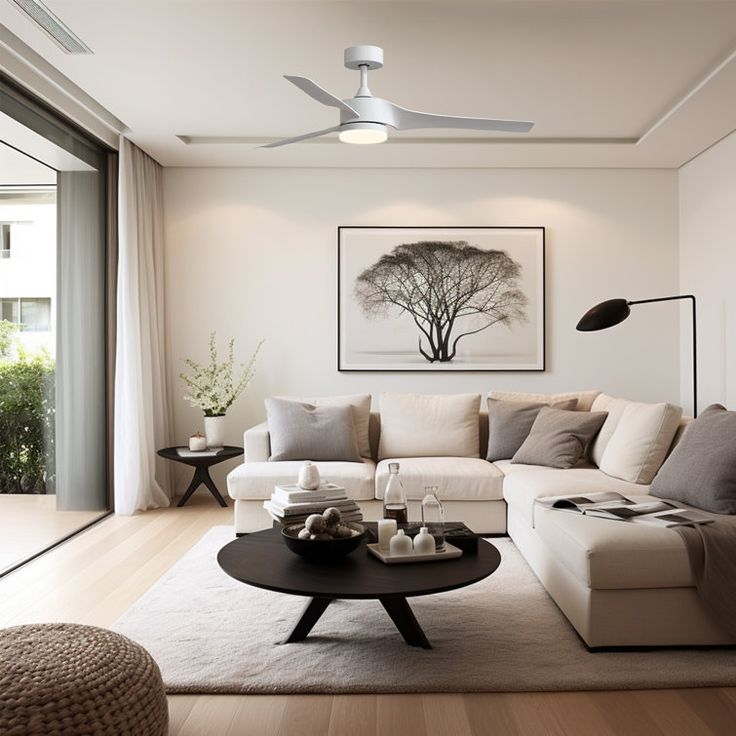 a living room filled with furniture and a painting on the wall above it's coffee table