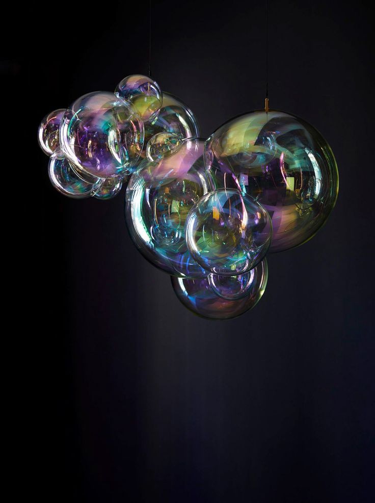 soap bubbles floating in the air on a black background