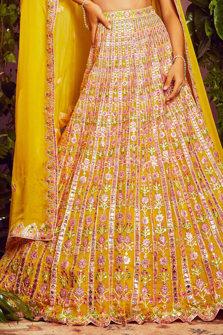 Yellow organza lehenga with all-over floral motif mirror-foil applique work and vertical striped detail. Comes with embroidered blouse and dupatta.
Component: 3
Embroidered
Neckline: V Neck
Sleeve Length: Sleeveless
Fabric: Soft Organza; Lining: Shantoon
Color: Yellow
Cutwork detail
V- back - Aza Fashions Yellow Organza Lehenga, Organza Lehenga, Yellow Soft, Applique Work, Embroidered Neckline, Bridal Lehenga, Vertical Stripes, Cut Work, Embroidered Blouse