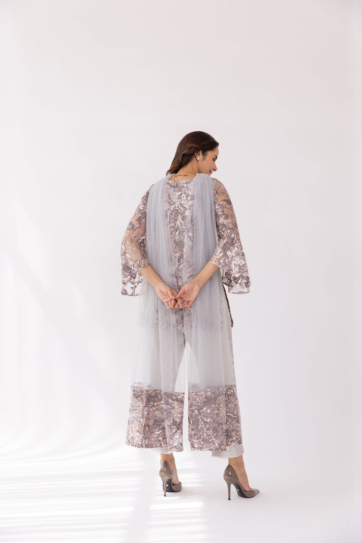 Featuring a silver embroidered boat neck kurta set in net base. It is paired with solid pants and net dupatta with sequin work. Color: SILVER FABRIC: NET Delivery time 15 to 20 days Eid Straight Kurta Palazzo Set With Sequins, Wedding Palazzo Set With Straight Kurta And Sequins, Wedding Palazzo Set With Sequins And Straight Kurta, Party Pant Set With Sheer Dupatta, Elegant Straight Kurta Palazzo Set With Sequins, Semi-stitched Sequined Anarkali Set With Straight Kurta, Sequined Straight Kurta Sharara For Reception, Elegant Palazzo Set With Sequins And Straight Kurta, Elegant Sequined Palazzo Set With Straight Kurta