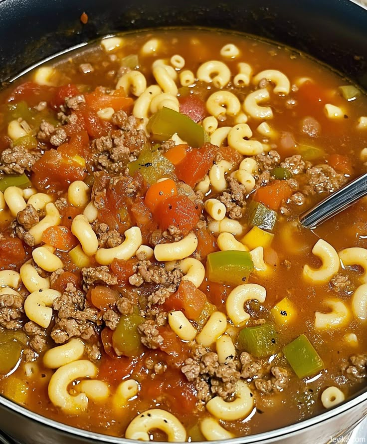 a large pot filled with pasta and meat soup