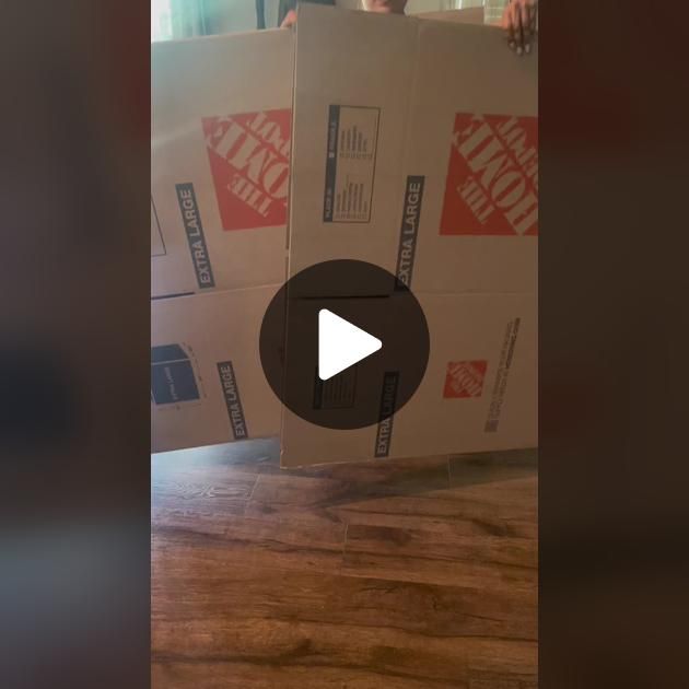 two boxes are stacked on top of each other and the box is being held up