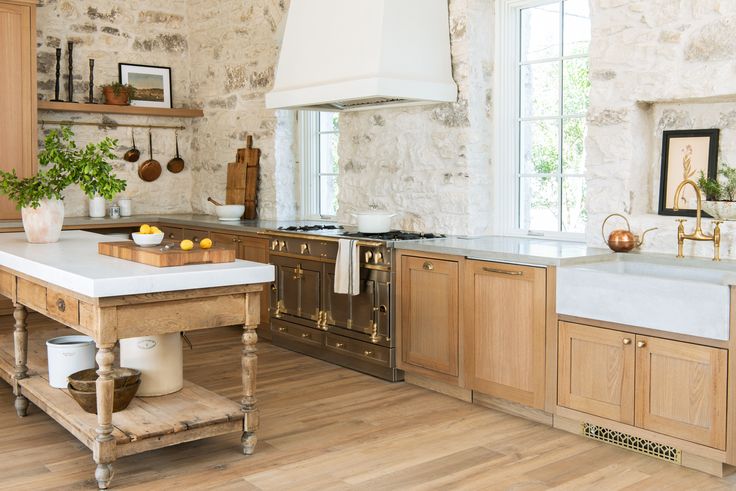 a large kitchen with wooden cabinets and white counter tops, along with an island in the middle