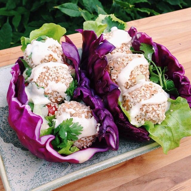 two lettuce wraps filled with meat and vegetables