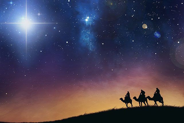 three people riding on camels in the desert at night with bright stars above them