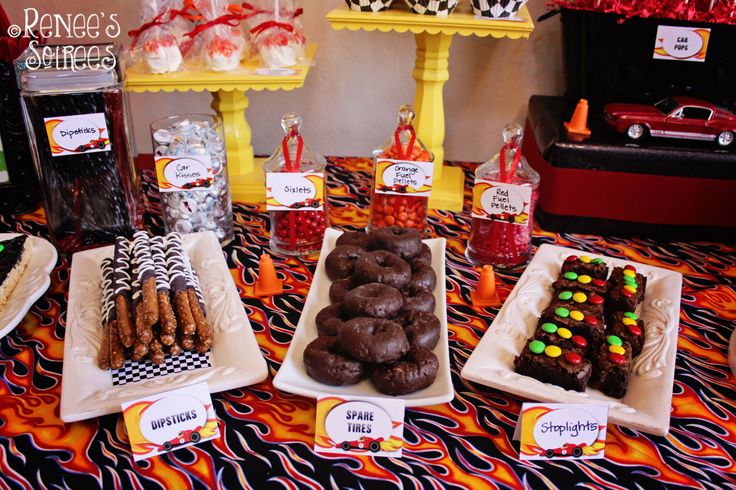 a table topped with lots of desserts and candy