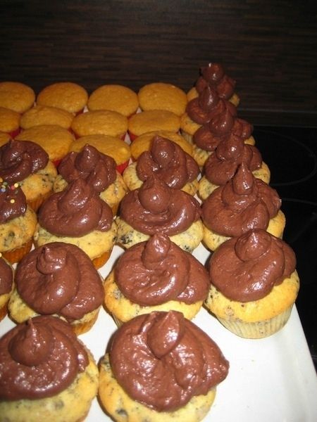 chocolate frosted cupcakes are arranged on a white platter and ready to be eaten