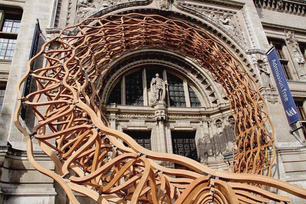 a large metal sculpture in front of a building