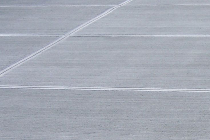 a man standing on top of a tennis court holding a racquet in his hand