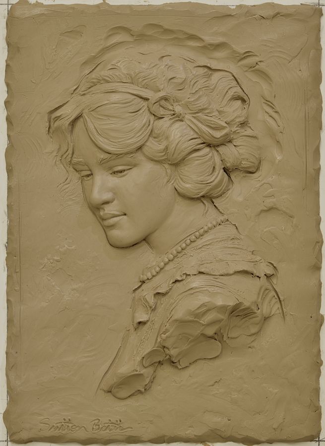 a clay sculpture of a woman's head