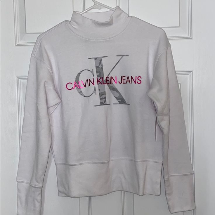 This Sweatshirt Is Really Cozy With A Small Turtleneck. It Has The Calvin Klein Logo In Camo Too! Turtleneck Sweatshirt, Calvin Klein White, Womens Calvin Klein, Camo, Top Brands, Calvin Klein, Color White, Turtle Neck, Womens Tops