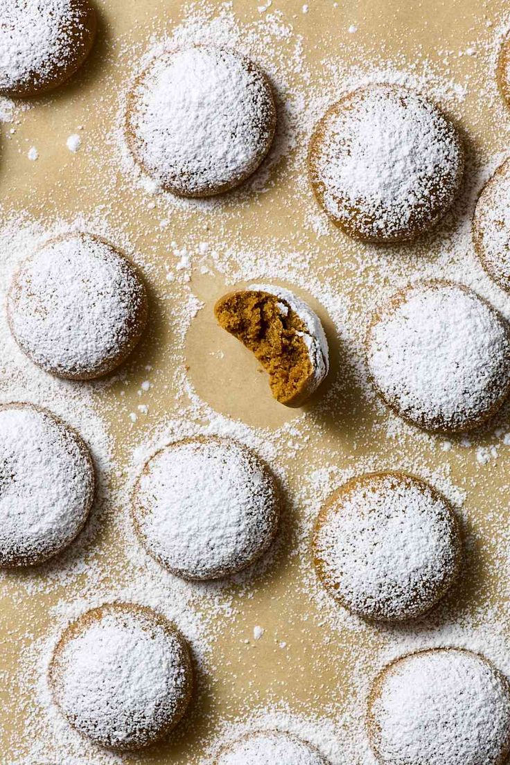 powdered sugar cookies are arranged on a cookie sheet