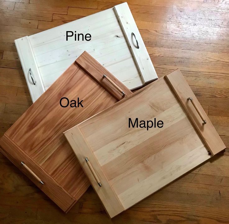 three different types of cutting boards on a wooden floor with the names pine, oak, maple and pine