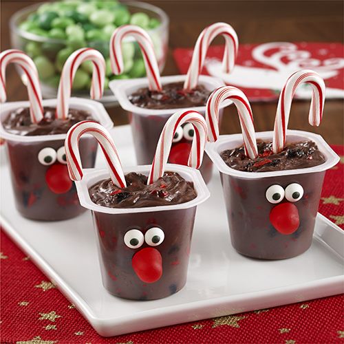 chocolate cups with candy canes and candies in the shape of a reindeer's nose