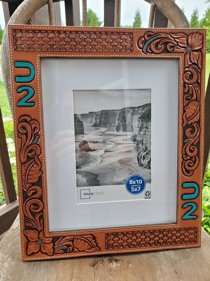 a wooden chair with a picture frame sitting on top of it