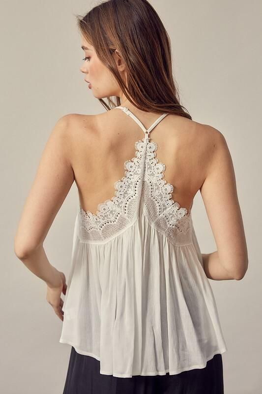 The Everything Sweet White Lace Trim Tank Top is always a delectable option! Adjustable spaghetti straps support a woven triangle bodice with surplice overlap halter top bodice. Eyelash lace decorates the overlap neckline and back. T-back and high low hem finish the look. DETAILS & CARE Rayon. Hand wash cold. Imported. Spring Delicate Camisole With Delicate Straps, Delicate Spring Camisole With Delicate Straps, Feminine Summer Camisole With Lace Bodice, Chic Lace Bodice Camisole For Spring, Spring Lace Bodice Camisole, Spring Lace Cami Top With Lace Bodice, Delicate Spaghetti Strap Tops For Summer, Wedding V-neck Camisole With Delicate Straps, Delicate Lace Cami Top