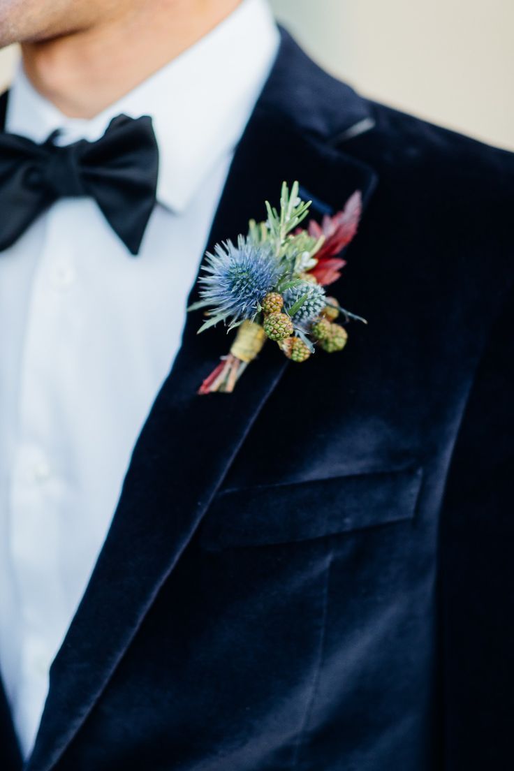 a man in a tuxedo with a boutonniere on his lapel