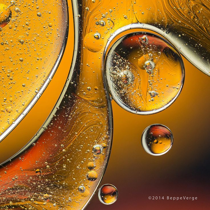 water drops on the surface of an orange and yellow object