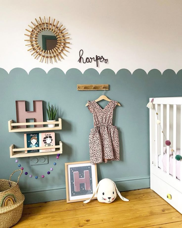 a baby's room with a crib and toys on the floor next to it