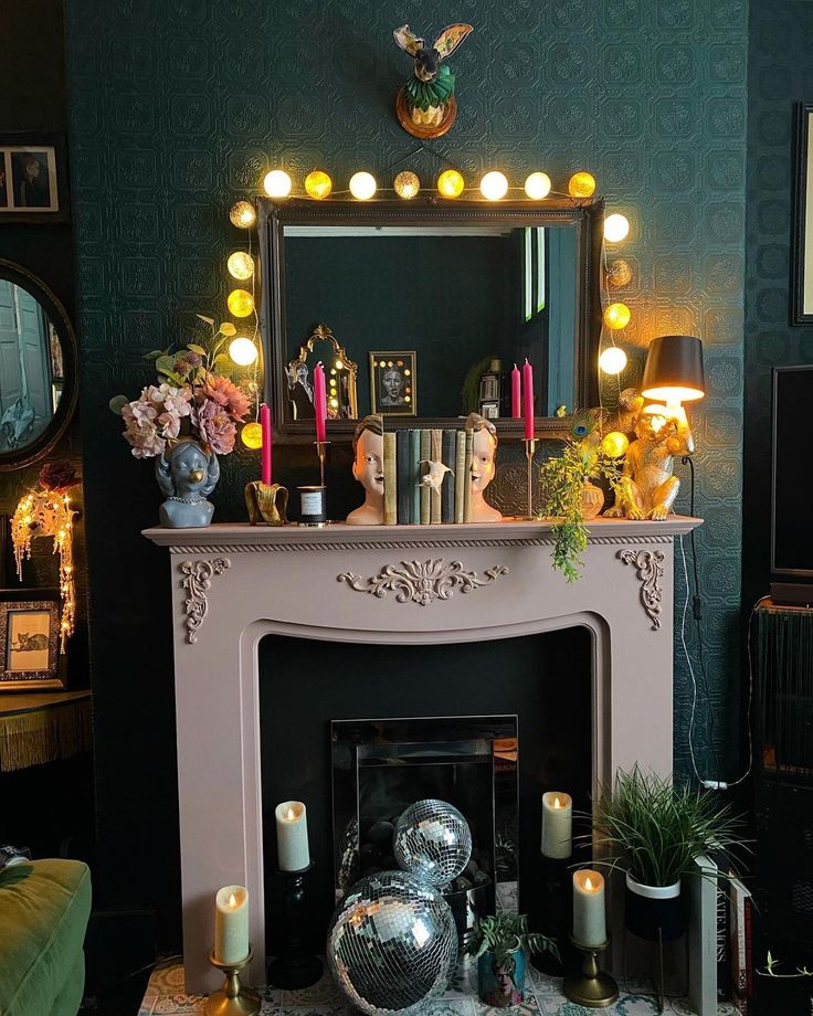 a living room with a fire place and mirror on the fireplace mantel, surrounded by candles