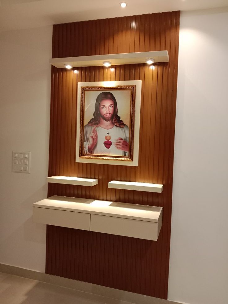 an image of jesus on the wall above two sinks in a room with wood paneling