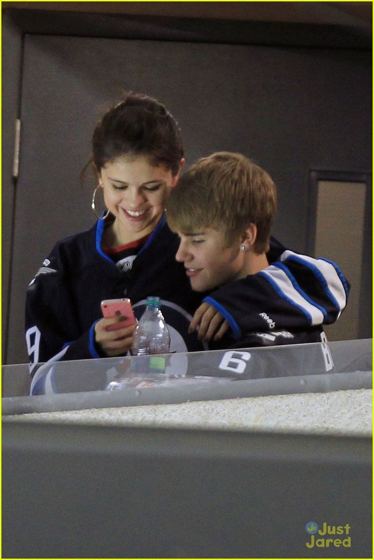 two young boys looking at their cell phones