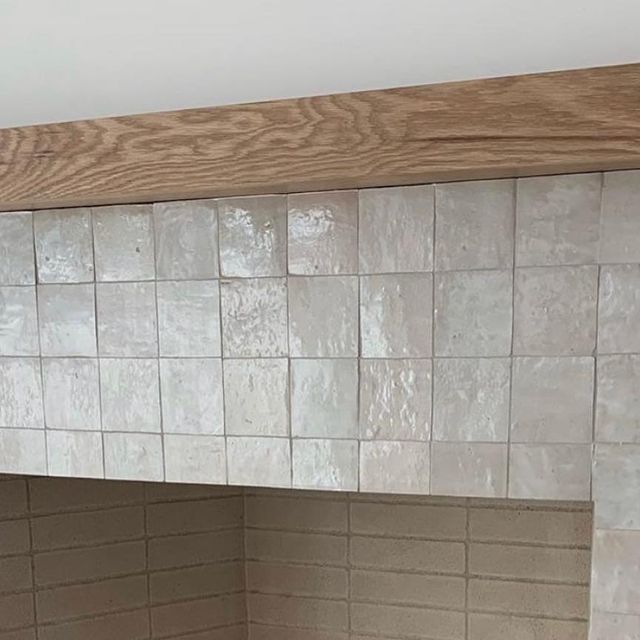 a stove top oven sitting inside of a kitchen next to a wall mounted faucet