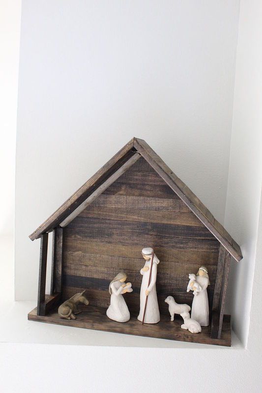 a nativity scene with figurines in the shape of a house and dog