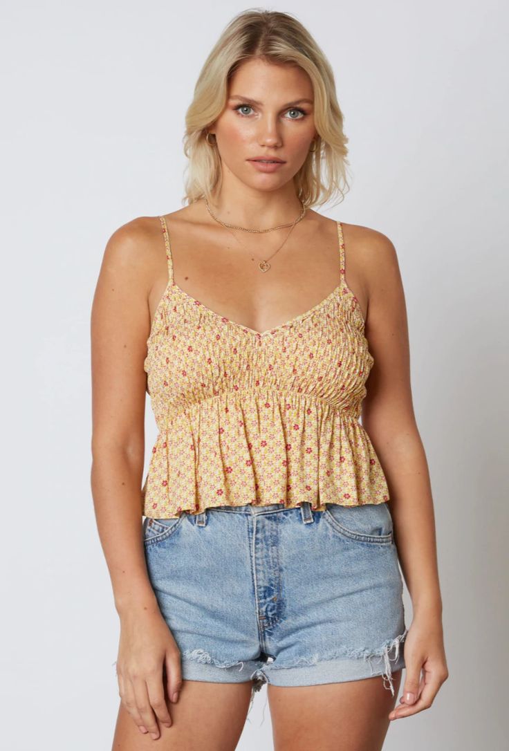 Update your basic style with the Gina Honey Floral Print Smocked V-Neck Ruffled Cropped Tank Top! A plunging V-neckline and shirred, cami strap bodice is made from rayon fabric (in a honey yellow and raspberry floral print), ending in a cute cropped and ruffled hem. Pair with your favorite ripped denim shorts for a cute warm weather look! Vacation Tops With Smocked Bodice And Ruffled Straps, Summer Tops With Smocked Back And Ruffled Straps, Smocked Top With Ruffled Straps For A Day Out, Vacation Tops With Smocked Back And Ruffled Straps, Summer Tops With Smocked Bodice And Spaghetti Straps, Bohemian Smocked Sleeveless Top For Day Out, Smocked Top With Spaghetti Straps For Day Out, Casual Tops With Smocked Back And Ruffled Straps, Fitted Smocked Bodice Top With Spaghetti Straps