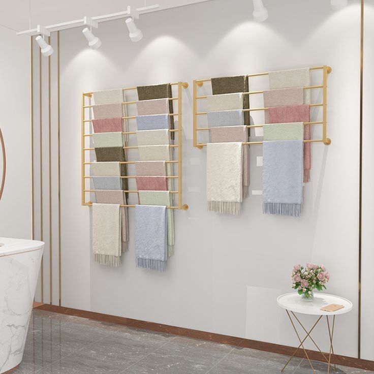 a bath room with a tub and two towels hanging on the wall next to it