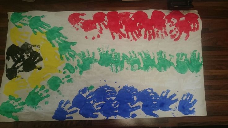 a child's handprinted flag is displayed on a table