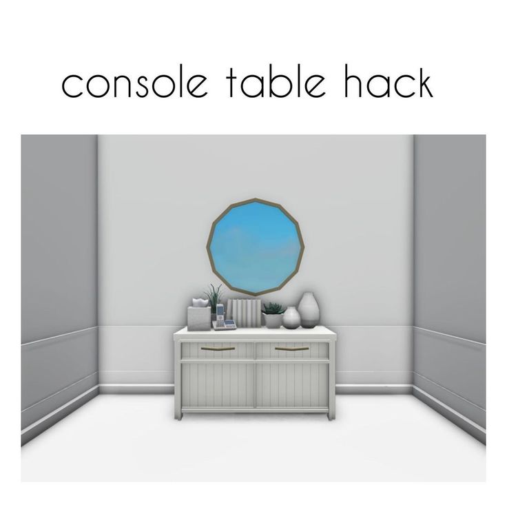 the console table hackr is sitting in front of a white wall with a blue mirror on it