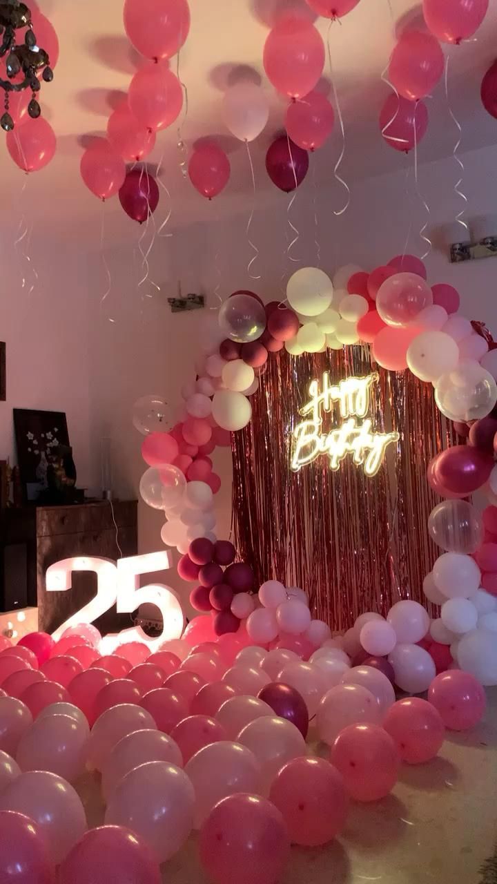 a room filled with balloons and streamers in the shape of letters that read 25