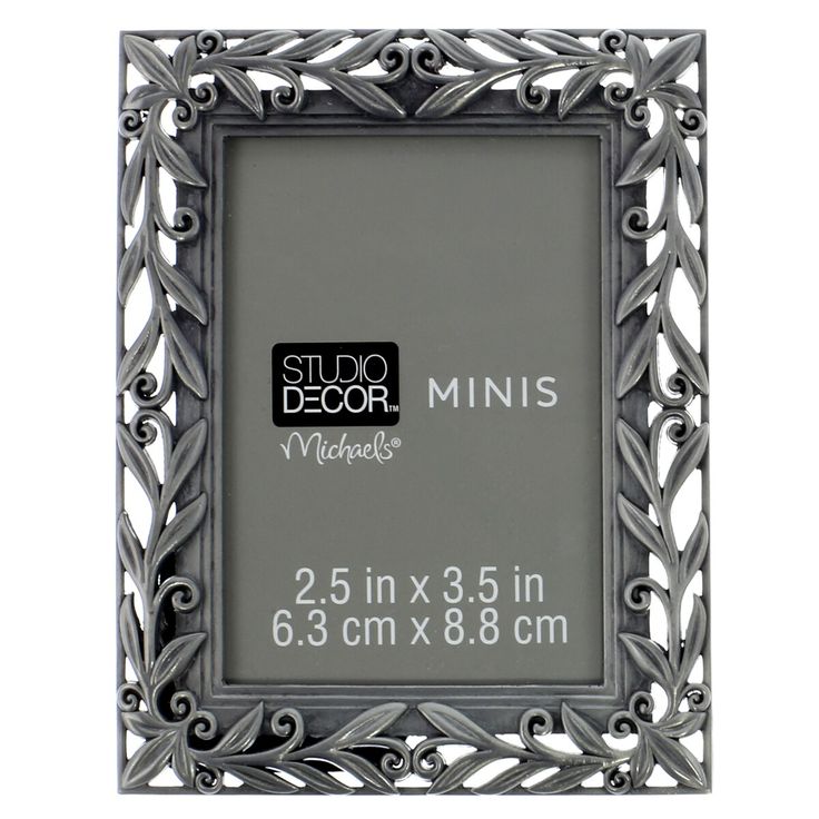 a metal frame with the words studio decor minis on it's front side