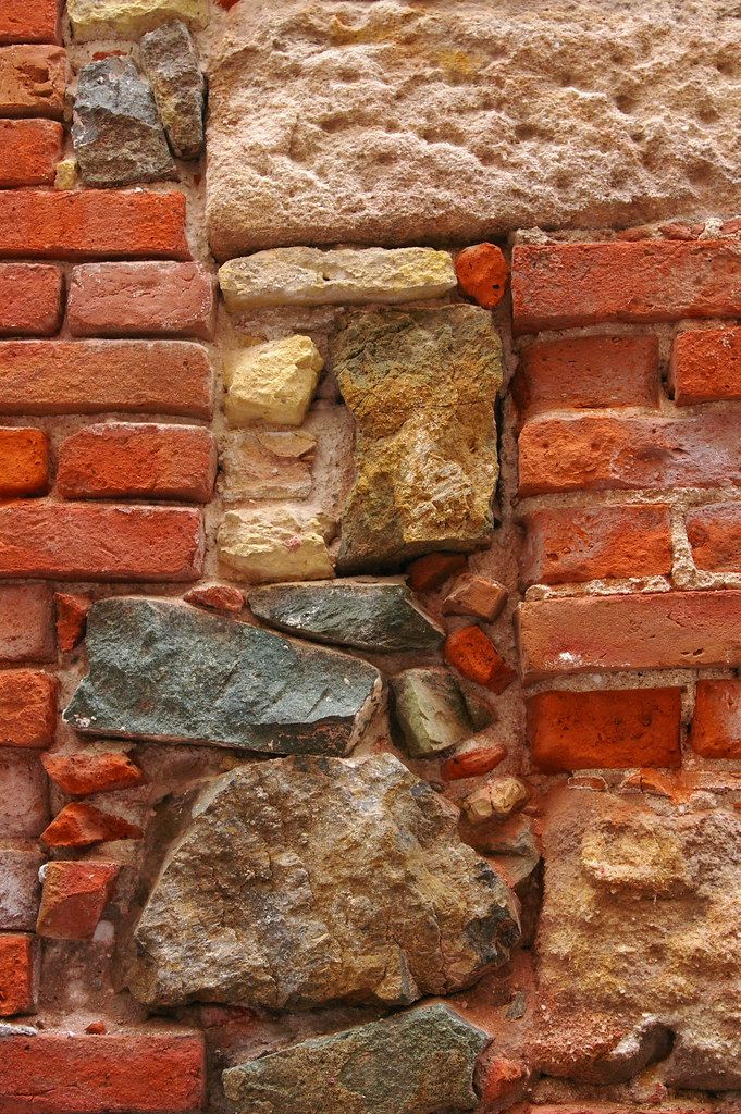 a brick wall that has been made with different colored bricks and mortars on it