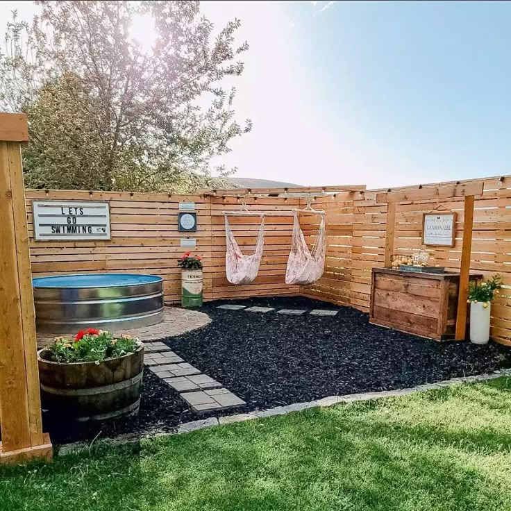 a backyard with a hammock, potted plants and an outdoor hot tub