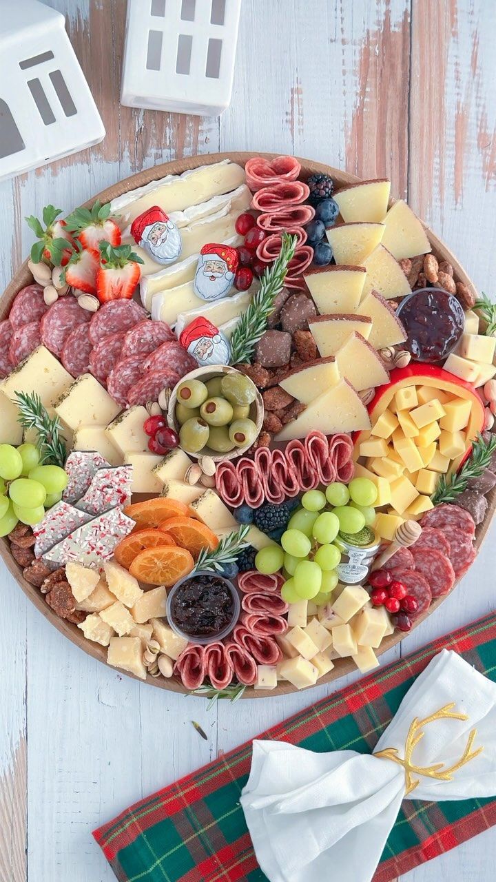 an assortment of cheeses and meats on a platter