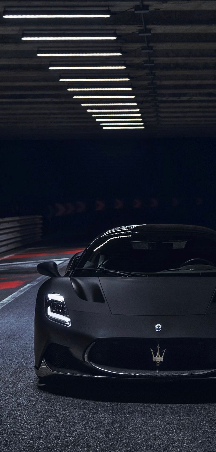 a black sports car driving through a tunnel