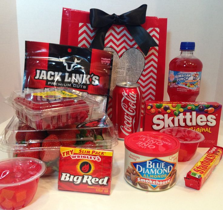 a variety of snacks and drinks sitting on a counter top next to a package of candy