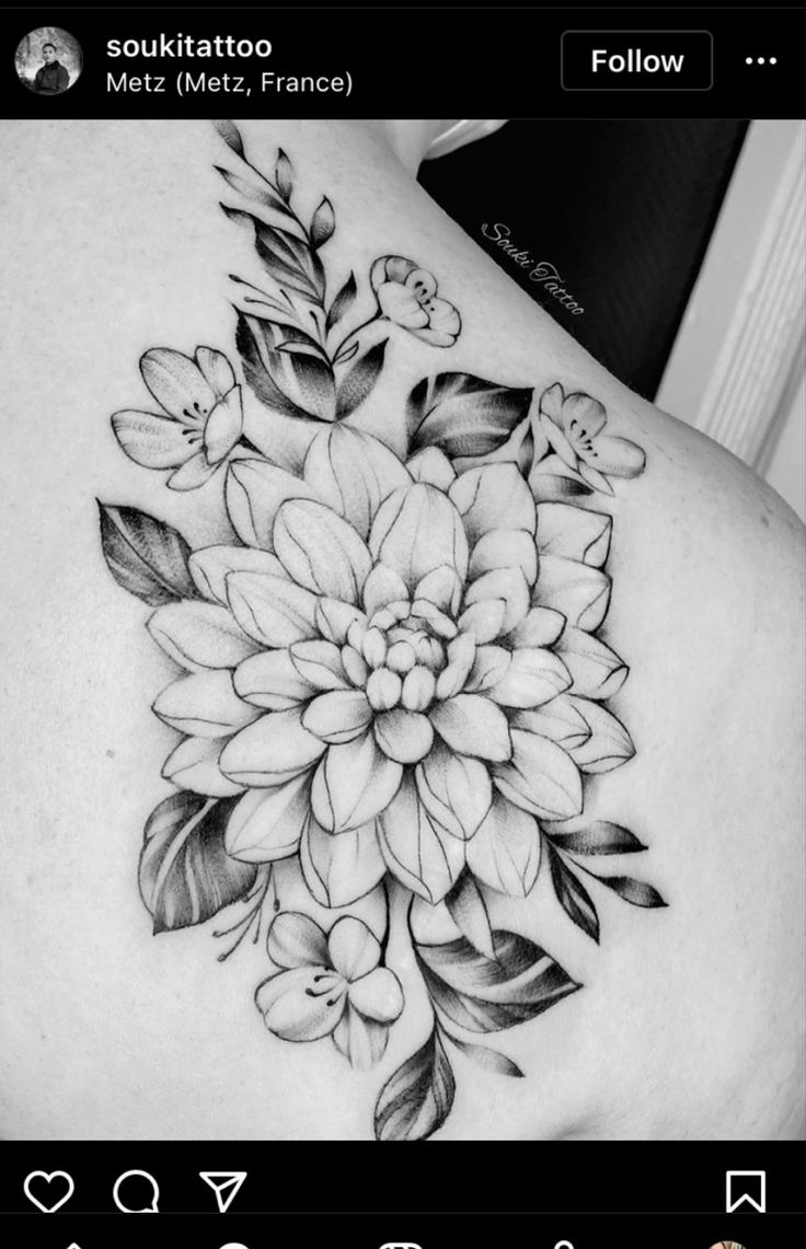 a black and white photo of a woman's back with flowers on it