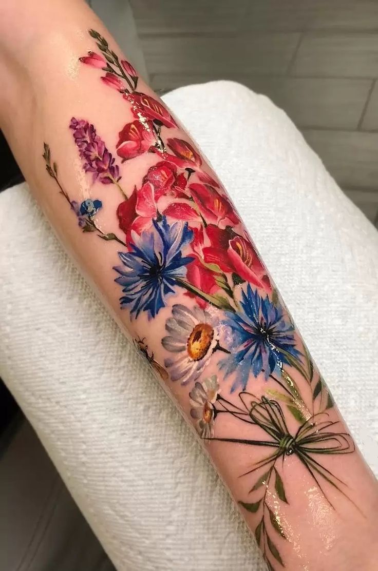 a woman's arm with flowers on it