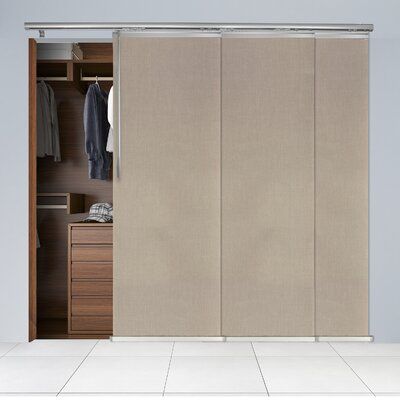 an open closet door with clothes hanging on it