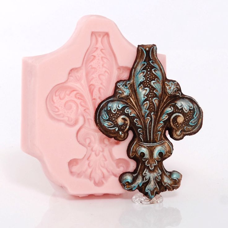 a close up of a soap bar with an ornate fleur de lis design on it